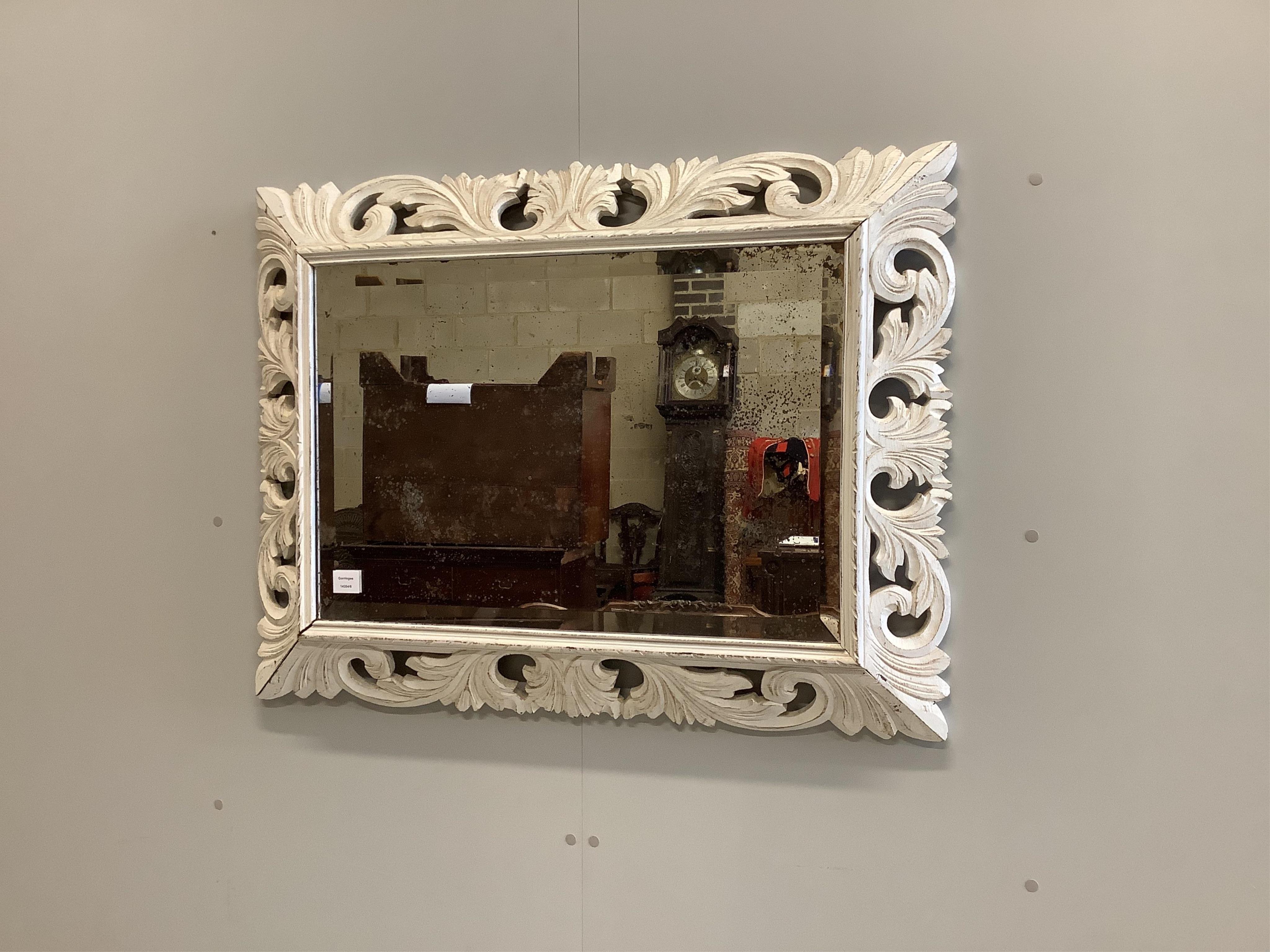 A wooden framed wall mirror, later painted, width 101cm, height 74cm. Condition - poor